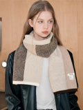 Close-up of a woman wearing a textured knit scarf