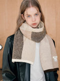 Front view of a woman with a warm, patterned scarf around her neck