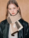 Woman wearing a beige and brown colorblock knit scarf