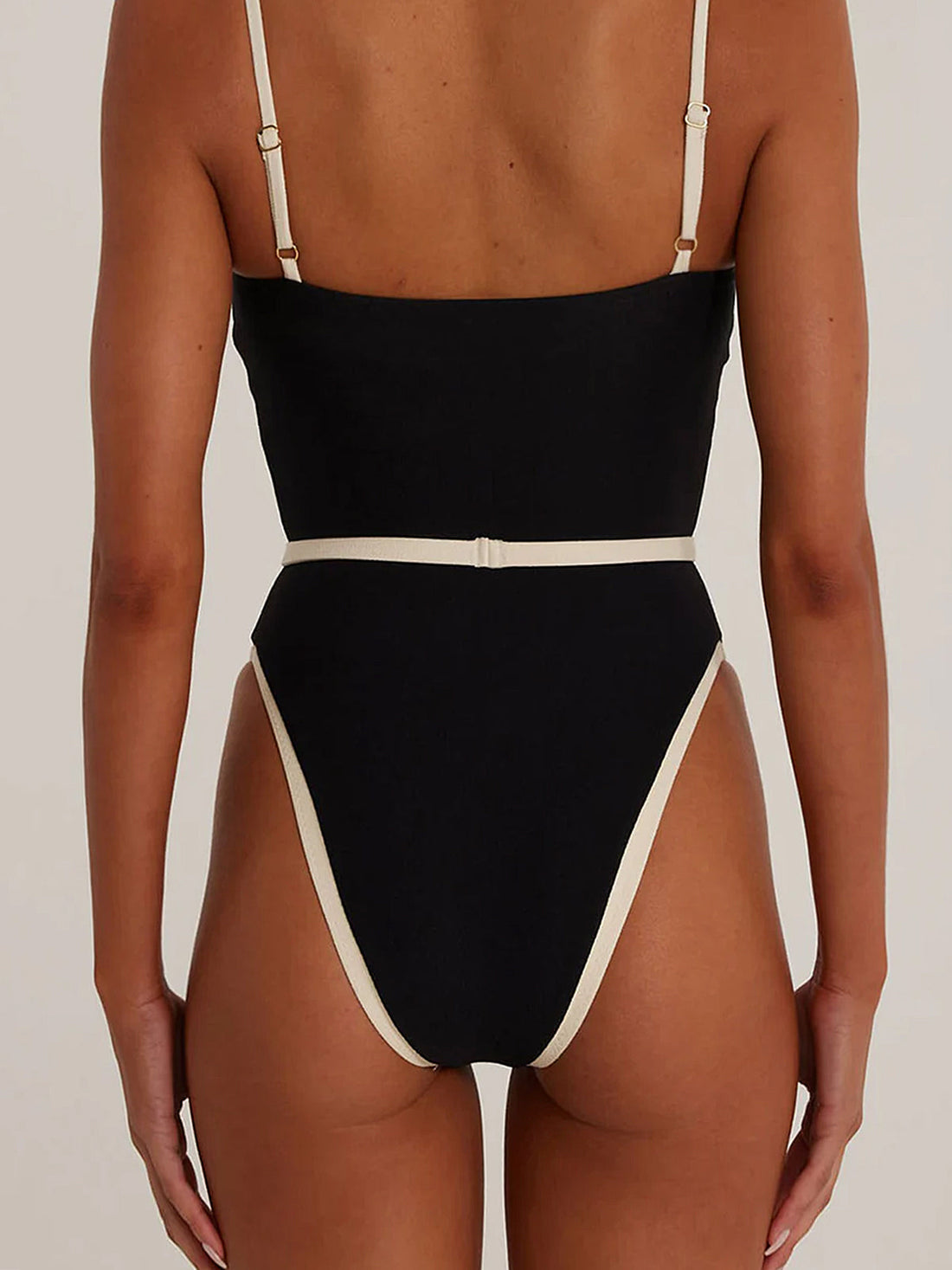 Front view of a black one-piece swimsuit with contrast trim and sweetheart neckline