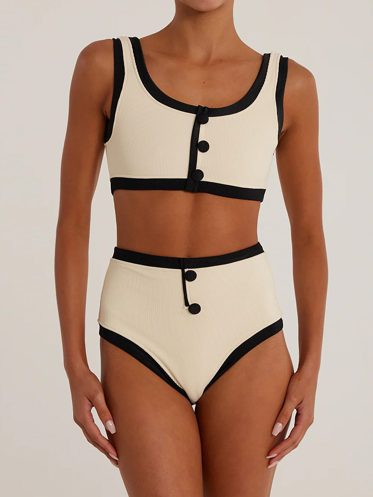 Cream ribbed knit bikini top with black trim and button details, paired with matching high-waisted bikini bottoms.