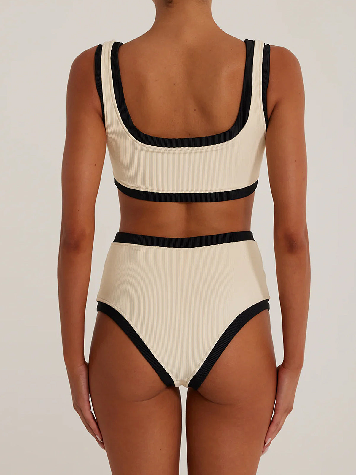 Back view of cream ribbed knit bikini set with black trim.