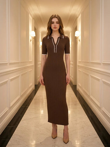 Woman wearing a brown ribbed knit midi dress with white collar trim, standing in a hallway.