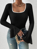 Front view of a woman styled in a black ribbed knit top with a square neckline and bell sleeves.