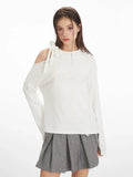Close-up of the asymmetrical shoulder detail on a white long-sleeve top, showing the bow and cut-out.
