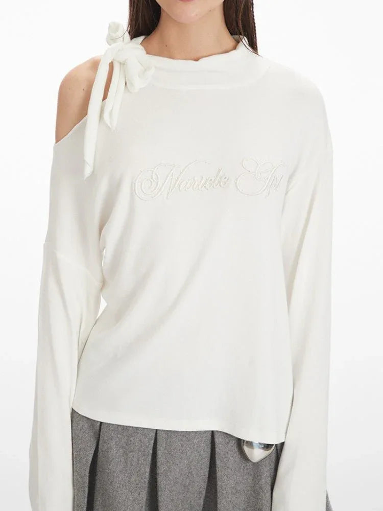 Off-white mock neck asymmetrical long sleeve top with a bow detail on the shoulder and embroidered graphic on the chest. - View 6 | WEUXS