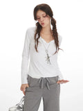 Woman adjusting her grey wide-leg fleece pants pocket