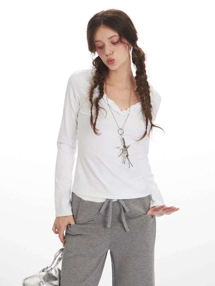 Woman adjusting her grey wide-leg fleece pants pocket