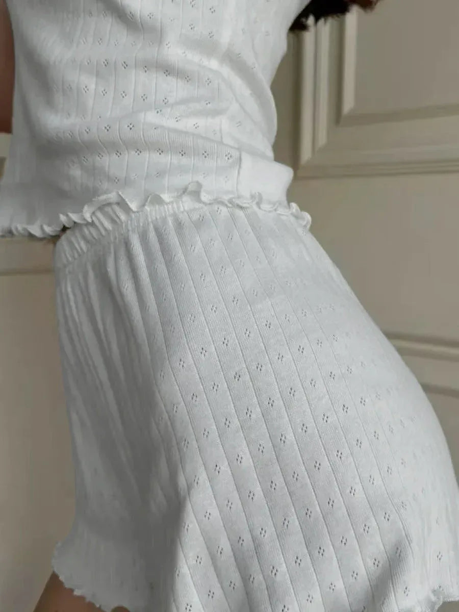 Detail of the ribbed texture and ruffled waistband on white shorts