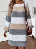 Close-up of a woman's hands on a striped sweater dress.