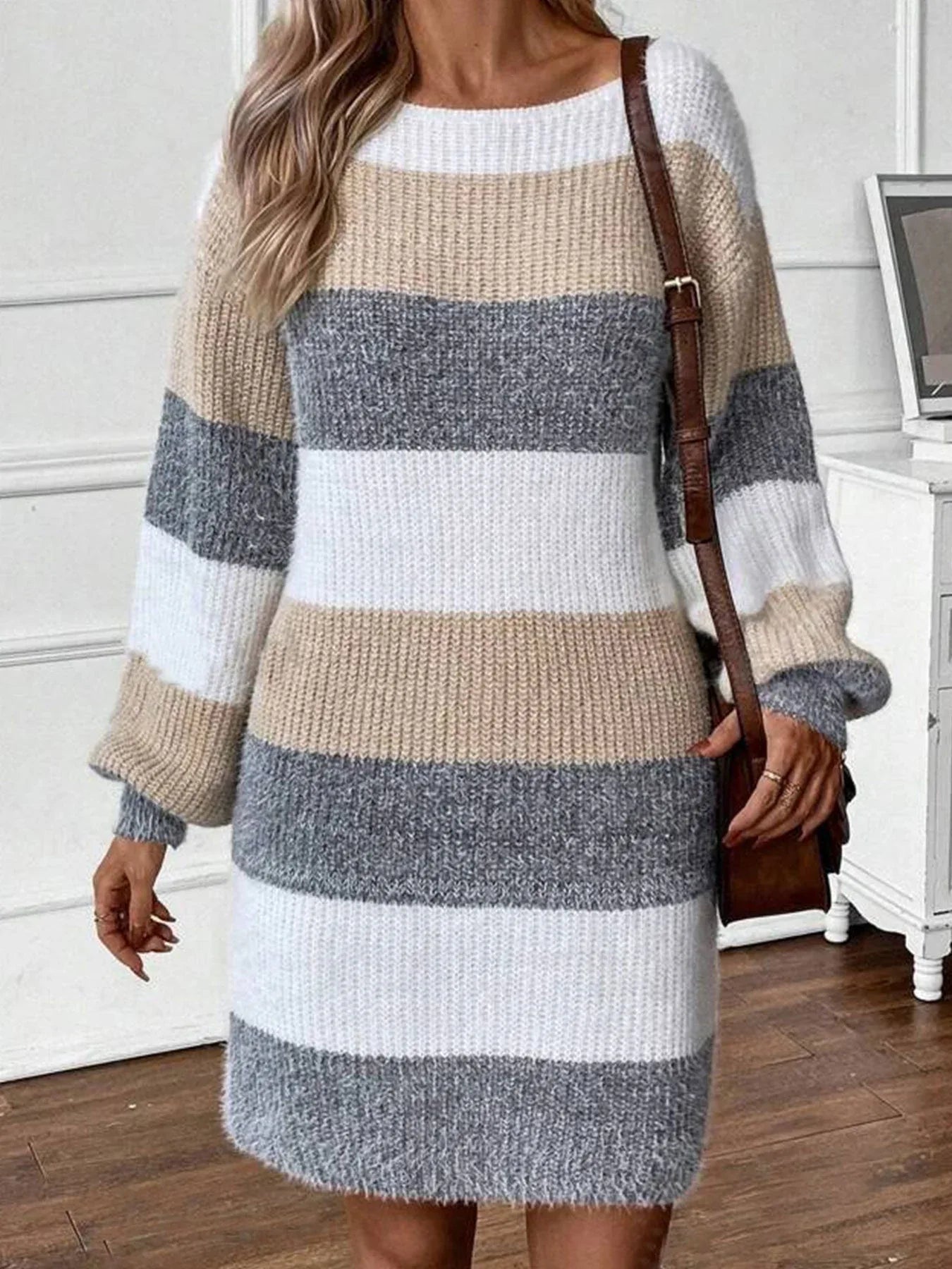Close-up of a woman's hands on a striped sweater dress.