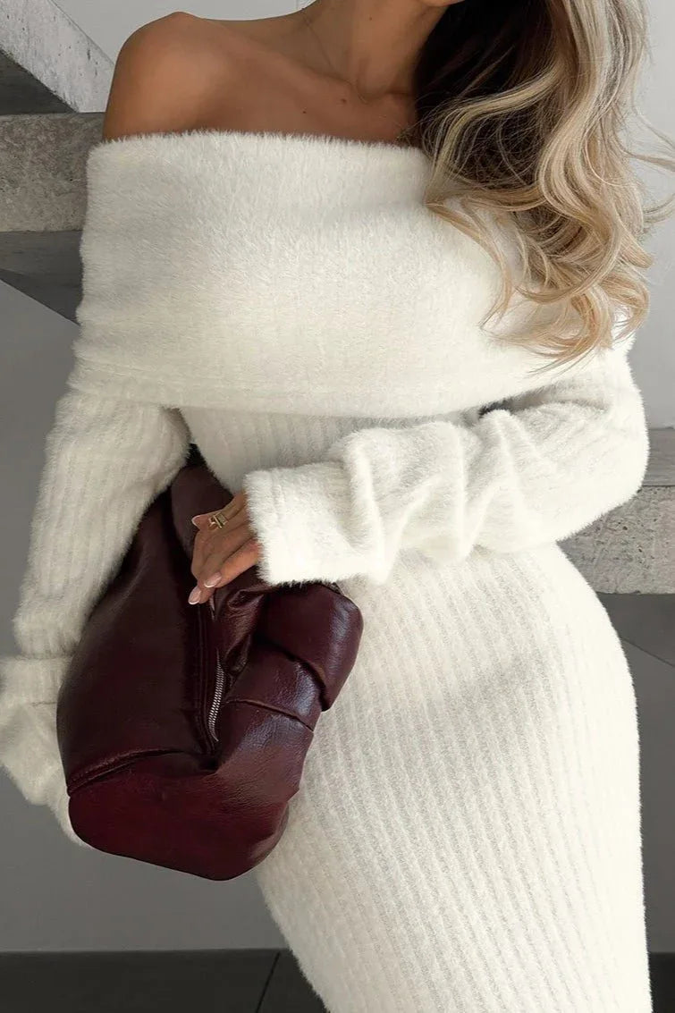 Close-up of a woman in a white off-the-shoulder knit dress
