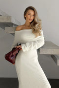 Woman wearing a white off-the-shoulder knit dress with long sleeves