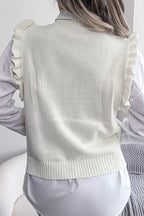 Back view of a woman wearing a white sleeveless knit vest with a diamond pattern and ruffle trim over a white button-down shirt.