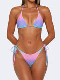 Woman wearing a gradient pink, purple, and blue rhinestone bikini with tie sides.
