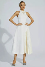 Model wearing a white halter neck midi dress with pleated skirt