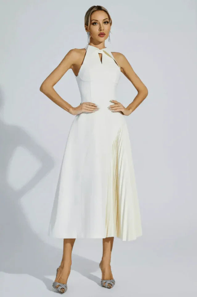Model wearing a white halter neck midi dress with pleated skirt