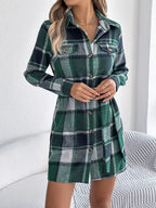 A woman poses in a green plaid shirt dress, showcasing its casual style.