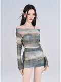 Close-up of the model wearing the printed mesh top and skirt, showcasing the off-the-shoulder detail.