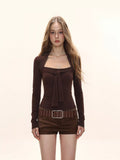 Woman wearing a dark brown long sleeve tie neck top