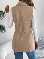 Back view of a woman in a beige corduroy longline vest.
