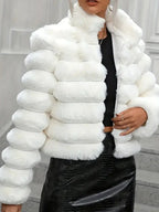 Close-up of a white faux fur jacket with a ribbed design