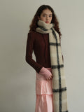 Close-up of a cream and black plaid scarf
