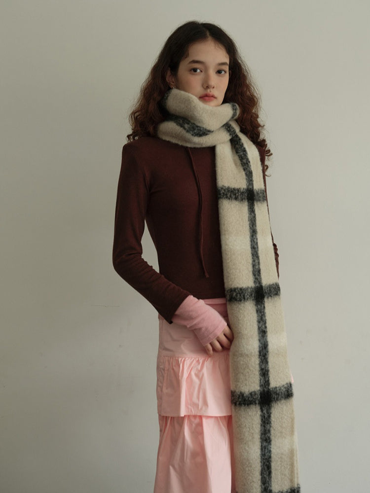 Close-up of a cream and black plaid scarf