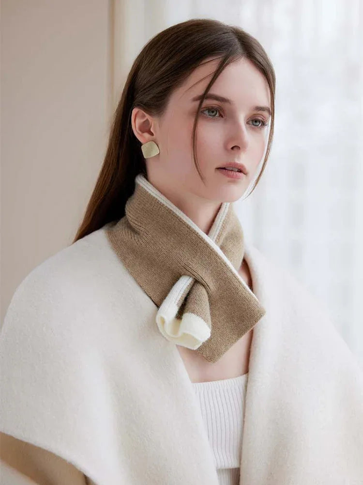 A woman models a soft knit scarf with a contrasting color block pattern