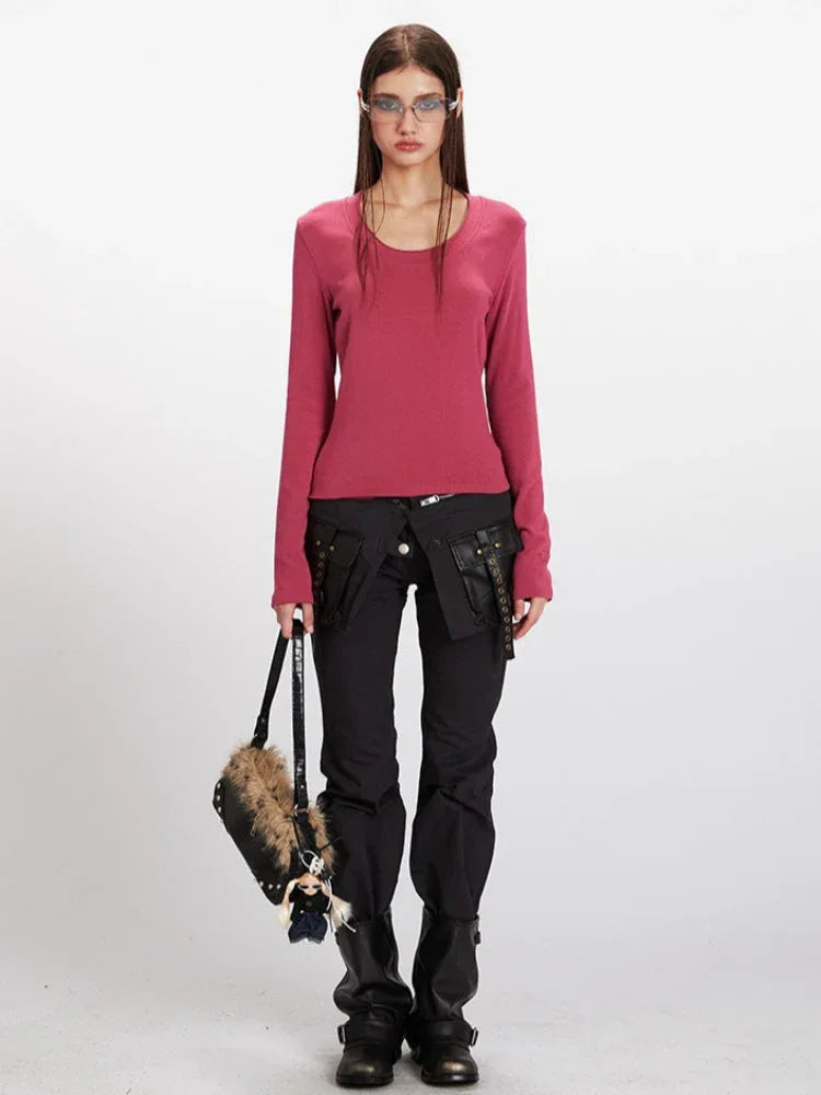 Woman wearing a rose red long sleeve scoop neck top