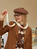 Front view of a woman in a brown blazer, displaying the two-button closure and welt pockets.