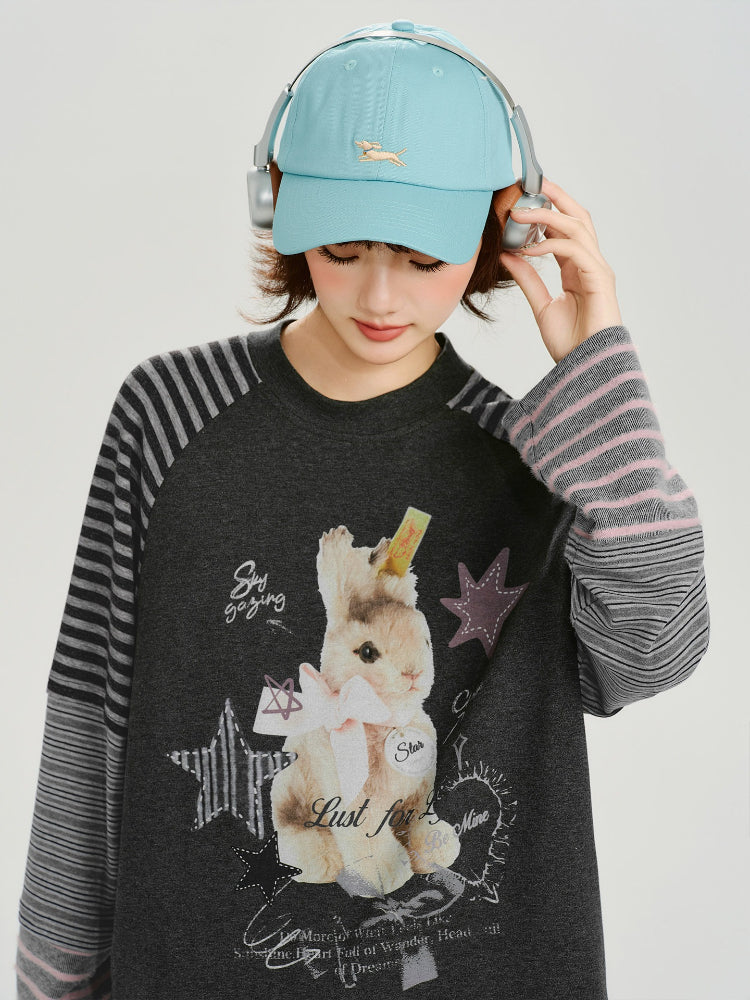 Side view of the woman, highlighting the striped sleeves and relaxed fit of the t-shirt.