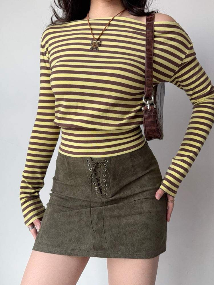 Full body shot of a woman in a striped top and olive green skirt, showcasing the garment's silhouette.