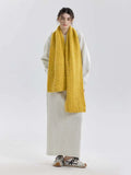 Full body shot of a woman in a yellow scarf and grey outfit