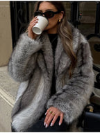 Woman wearing a grey faux fur coat and black pants
