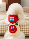 Back of a dog wearing a yellow hoodie with 'SMILE WITH ME' text and a red graphic face