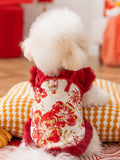 Rear view of a white dog wearing a red dog coat with traditional Chinese style closure and floral embroidery