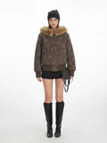 Woman wearing a brown bomber jacket with a star pattern and fur collar