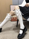 white knee-high socks with white bows and black platform Mary Jane shoes