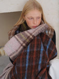 Close-up of a woman wearing a plaid scarf