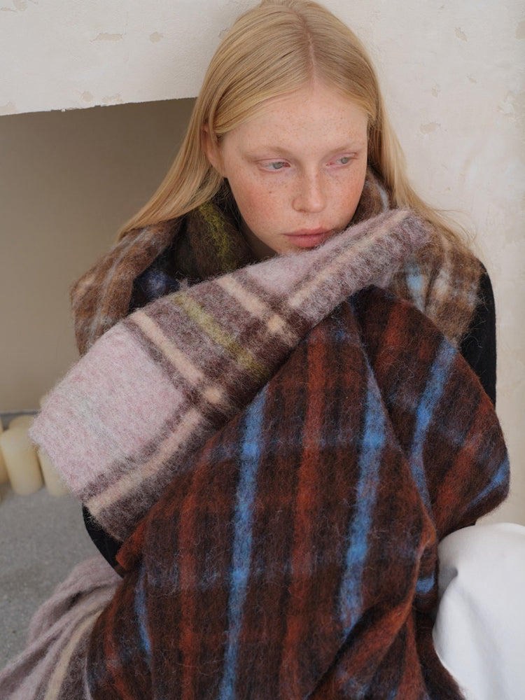 Close-up of a woman wearing a plaid scarf
