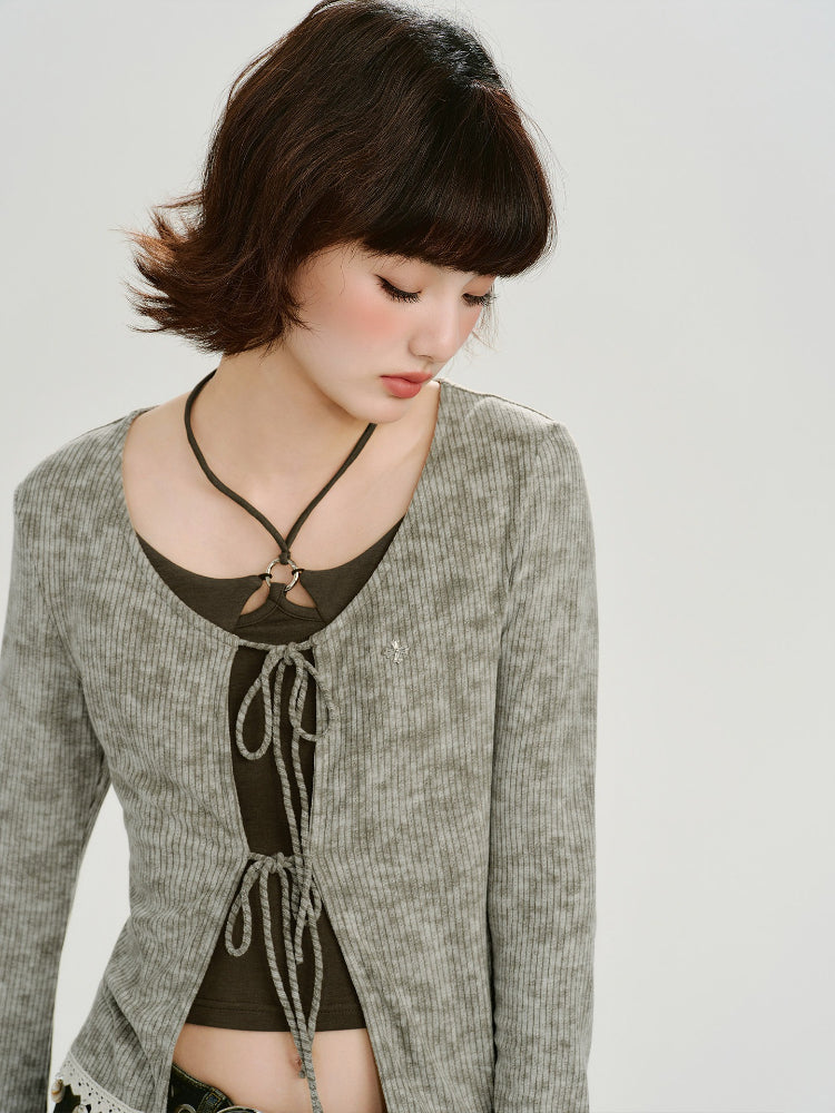Detail of the neckline and tie front of the grey cardigan