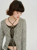 Detail of the neckline and tie front of the grey cardigan
