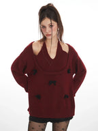 model posing in a burgundy layered knit sweater