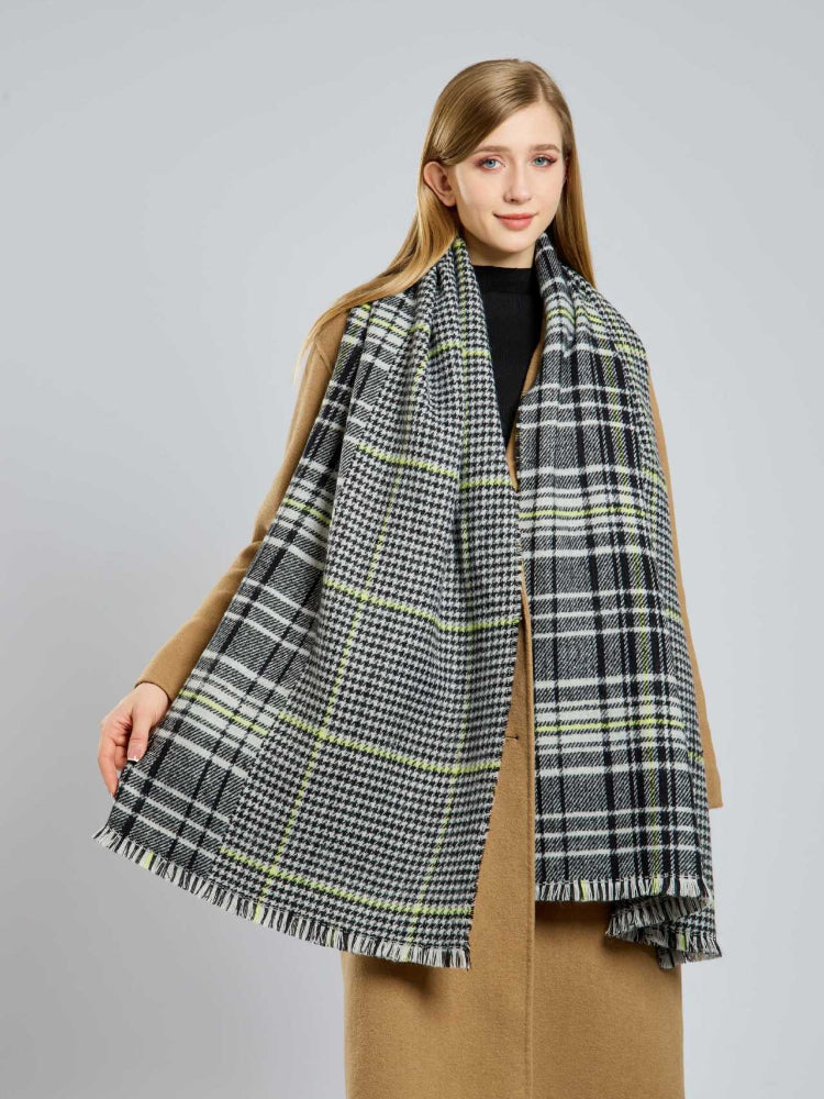 Close-up of a woman's plaid scarf with fringe.