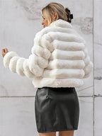 Back view of a woman in a white faux fur jacket