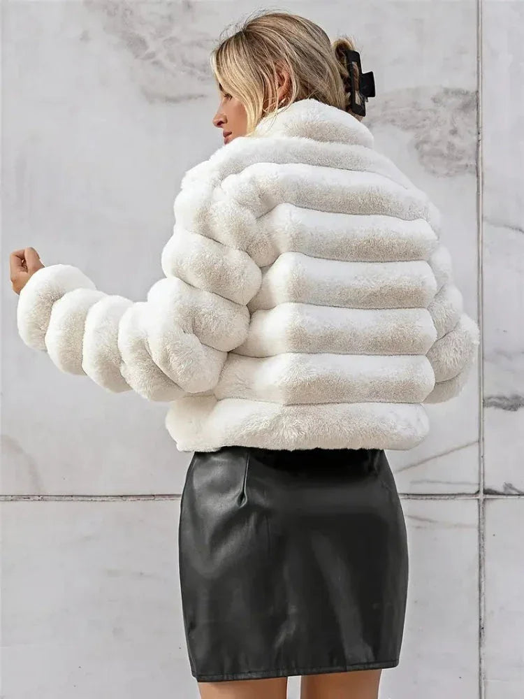 Back view of a woman in a white faux fur jacket