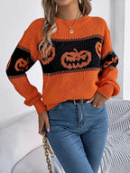 Close-up of the textured knit fabric on the orange sweater.