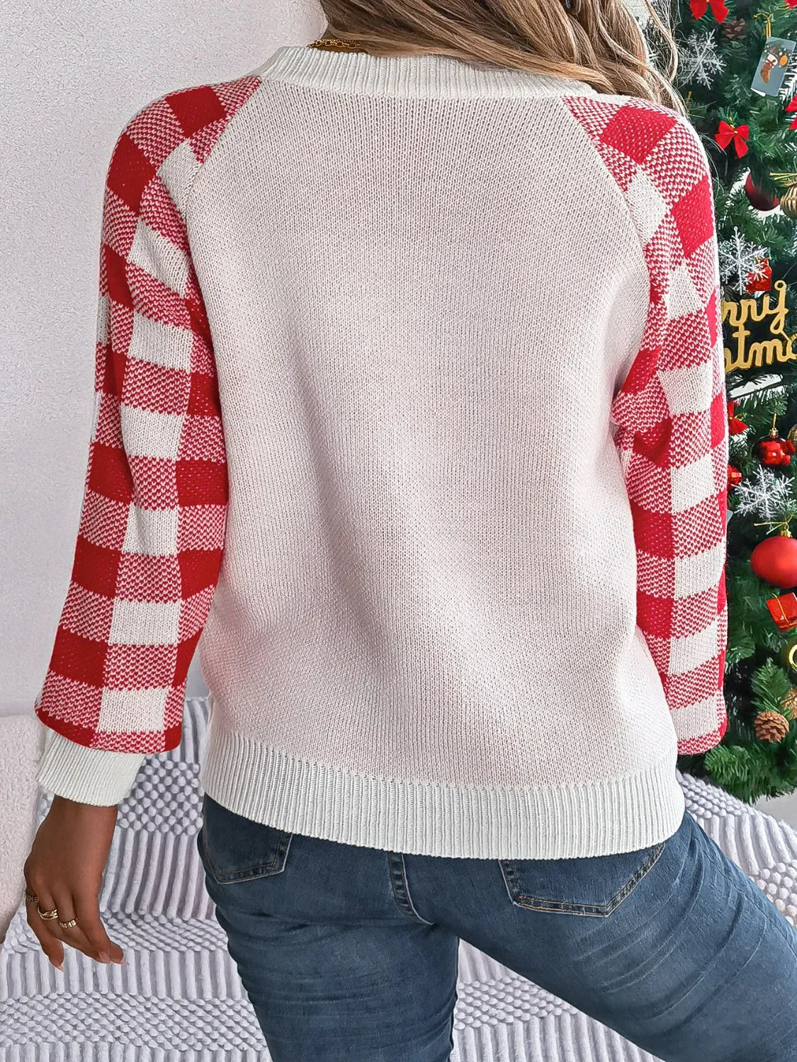 Back view of woman in red and white buffalo plaid sleeve sweater