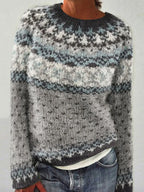 Woman wearing a grey and blue Fair Isle knit sweater with jeans